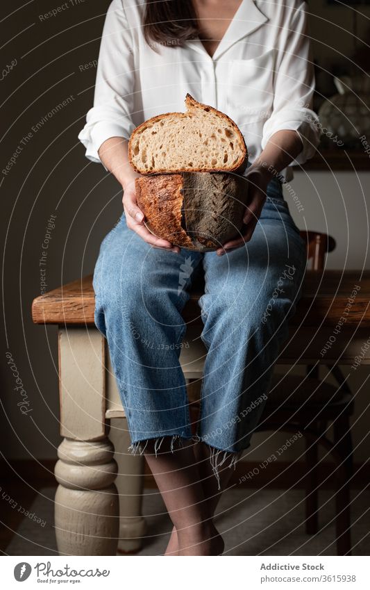 Crop woman with fresh bread delicious baked kitchen bakery table loaf nutrition female homemade pastry food tradition sit wooden meal tasty gourmet lady healthy