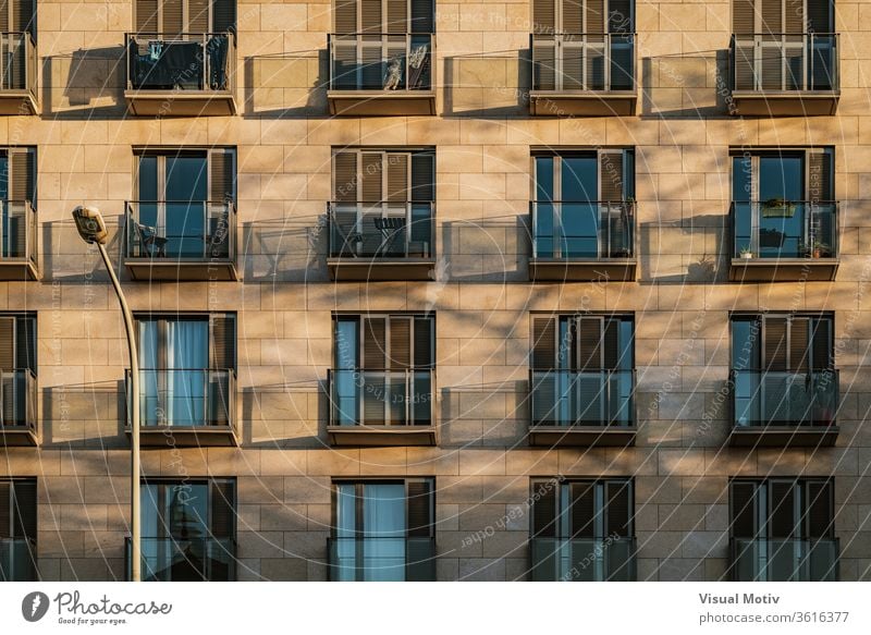 Shadows of modern balconies over a stone facade at the afternoon light building shadow balcony exterior apartment contemporary architecture construction
