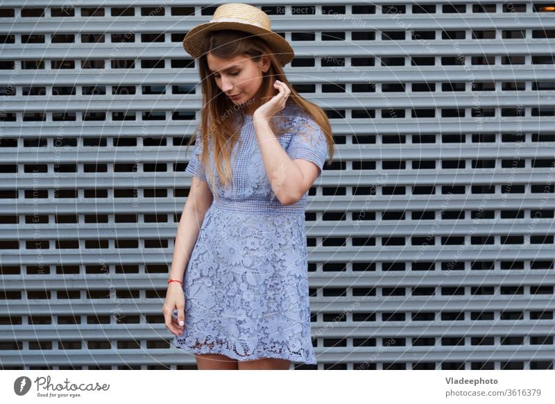 Portrait of a beautiful graceful woman in elegant hat and blue lace dress. Beauty, fashion concept summer young girl model female beauty lady attractive