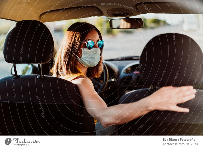 young woman in wearing protective mask. Summer season. prevention corona virus concept car pandemic covid driving driver travel summer sunset trip adult breath