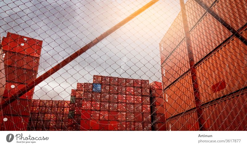 View from fence of red container stacked. Container logistics. Cargo and shipping. Import and export logistics business. Container freight station. Logistic industry. Container for truck transport.