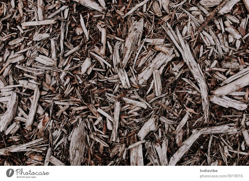 Wood chip pieces on the ground in different shapes and sizes wood texture dry brown nature dried plant black organic macro closeup natural mulch agriculture