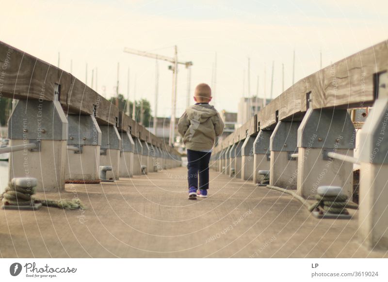 boy walking on a bridge Bridge way Dream Posture Considerate Peace Nature Calm Exterior shot Freedom tranquil Emotions Expression Sadness Loneliness Remote