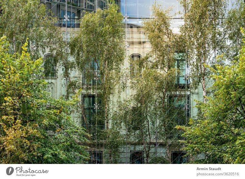 old house behind a modern glass facade with trees in foreground covered architecture nature building two reflection mirroring city urban berlin potzdamer platz