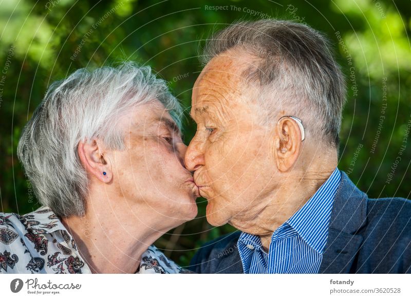 Seniors in love with a kiss Person Luck Kiss married Intimacy touch Tenderness Relationship Park Partner Closeness across from Trust People happy ripe