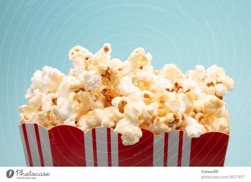 Salted Popcorn popcorn snack isolated paper white background cup movie red cinema nobody food entertainment salty delicious bucket carton box classic big large