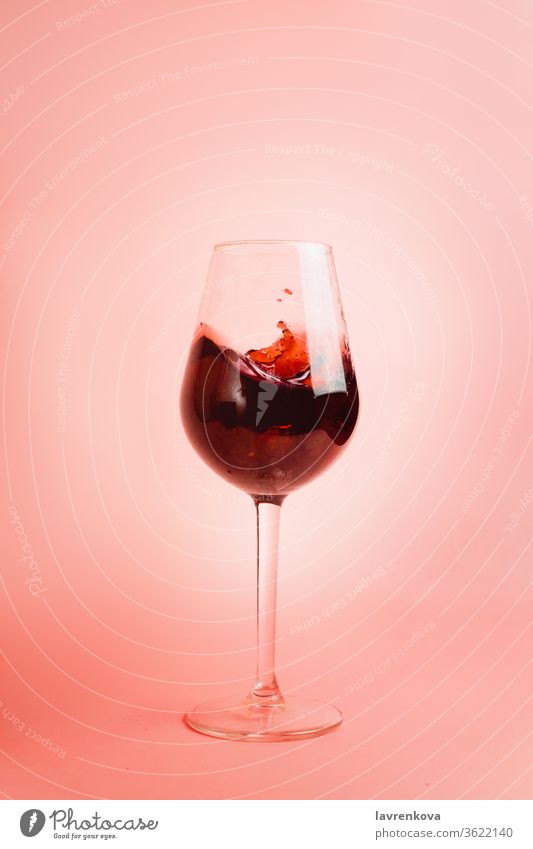 Red wine splash in a glass, dynamic picture, selective focus. liquor pouring droplet liquid winery red beverage drink celebration alcohol pink motion drops