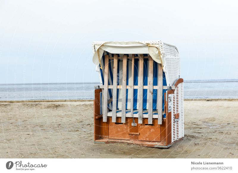 Beach chair at the North Sea beach in Germany beach chair Chair White Ocean Sky Water Blue travel Landscape Nature Coast Summer bank Wave cloud Sand Picturesque