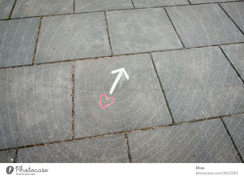 A heart and an arrow drawn with chalk on the floor Heart Love relation Arrow Road marking Direction off Emotions Love life Search Find Chalk Drawing concept