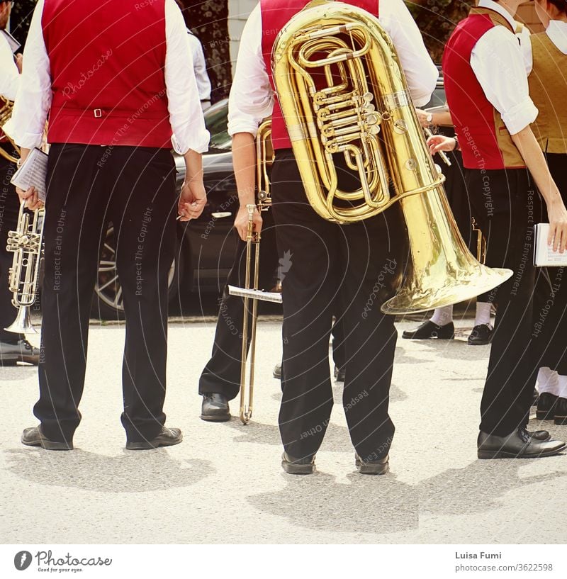 Brass band musicians in Bavarian costume with their instruments  attending a traditional parade brass festival Germany Bavarian town Munich folklore Tracht