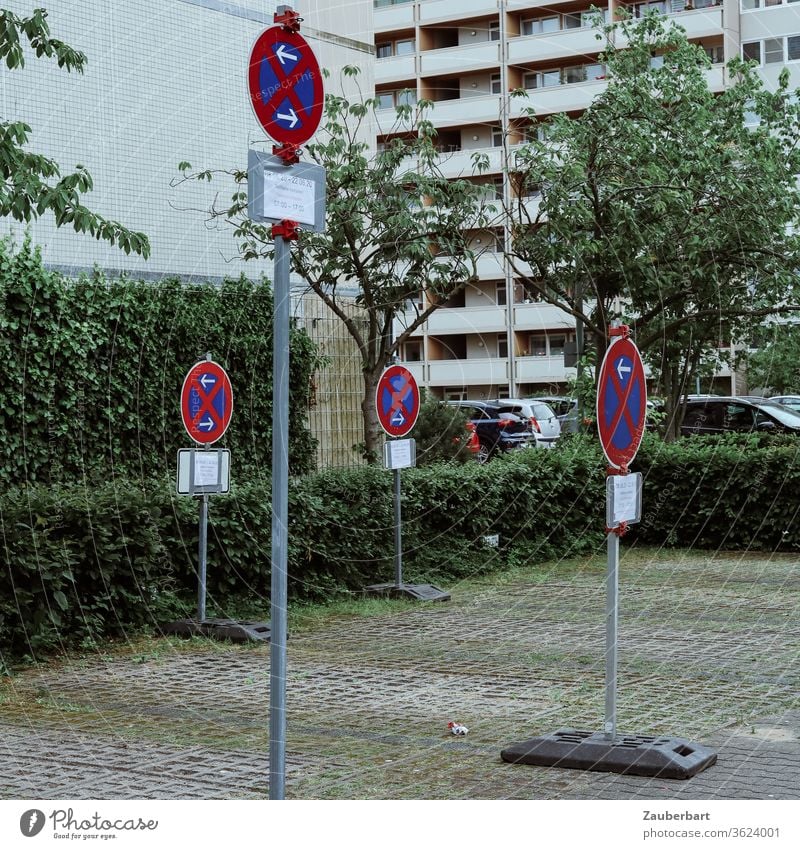 No stopping signs on a parking lot in front of the facades of high-rise buildings in Berlin-Tegel No standing Clearway Signs Road sign Parking lot Facade