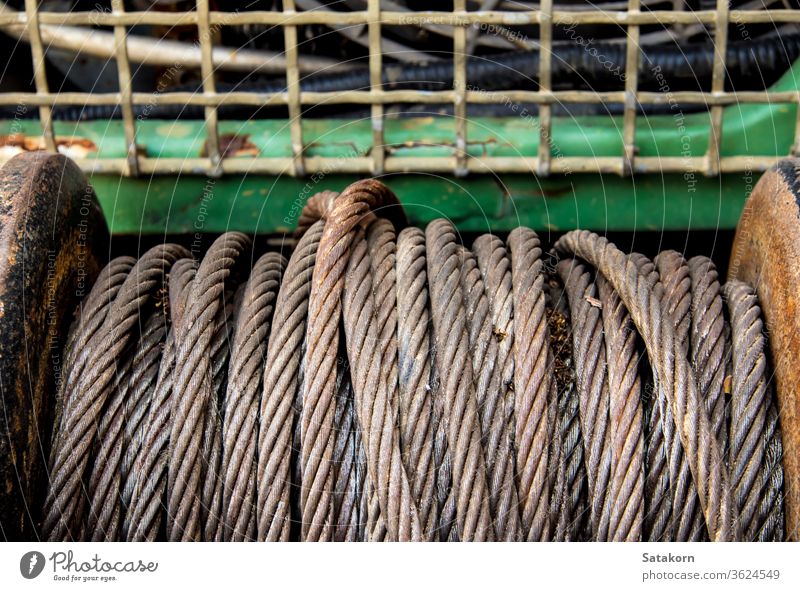 Old sling cable of electric winch in front of 4wd car steel old metal equipment vehicle rust rope gear hoist tow close up help pull off road