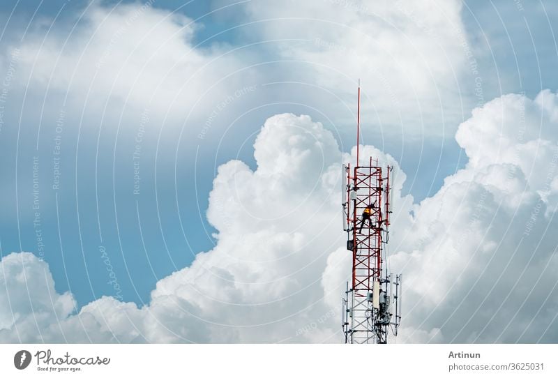 Telecommunication tower with blue sky and white clouds. Worker installed 5g equipment on telecommunication tower.Communication technology. Telecommunication industry. Mobile or telecom 5g network.