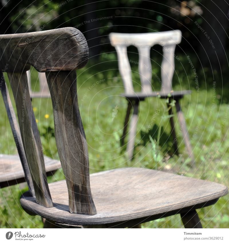 Chair circle, partial view Wooden chair Backrest chair legs Seat Seating wood Old Brown Furniture Grass Meadow green Deserted Loneliness