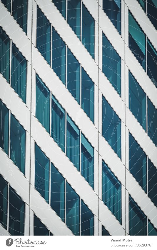Symmetrical blue windows of an office building made of aluminum and glass abstract abstract background abstract photography afternoon architectonic