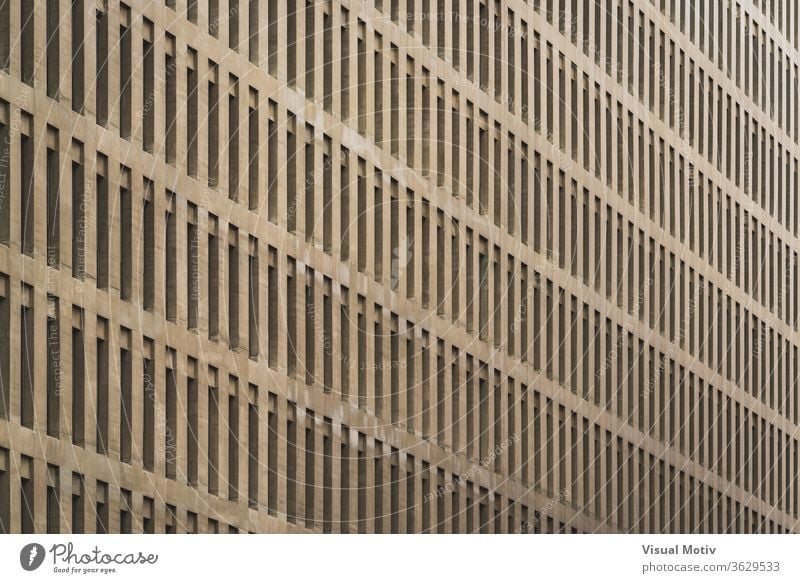 Uniform facade of an office building with rows of vertical windows structure architecture urban metropolitan abstract color exterior repetition pattern outdoors