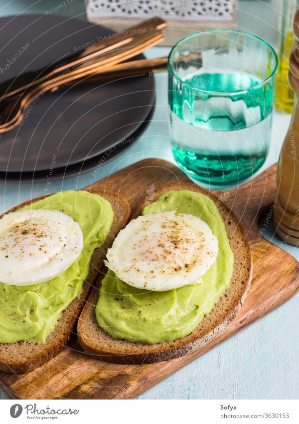 Rye bread avocado toasts with poached egg food rye black dish cream cook delicious sandwich open lunch meal brunch vegetarian smashed protein trendy savory