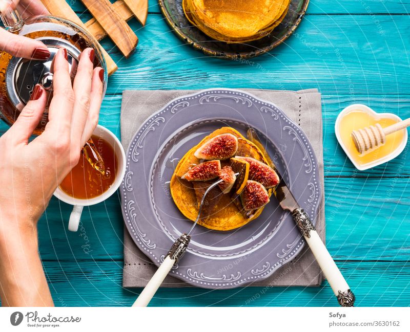 Eating pumpkin pancakes with figs and honey squash autumn fall green food fruit halloween winter breakfast eat dessert morning plate stack sweet vegetable meal