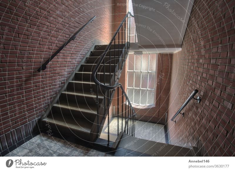 Stairwell in appartment building with brick wall, staircase antique old style complex with tall windows interior architecture stairwell design house stairs