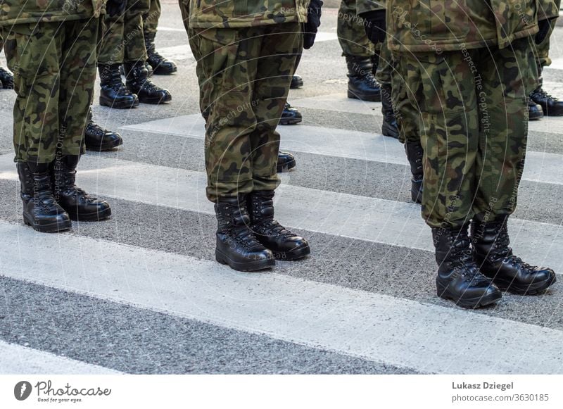 Soldiers standing on the street in a military uniform with camouflage and black military boots soldiers troops combat boots boot camp platoon veterans day