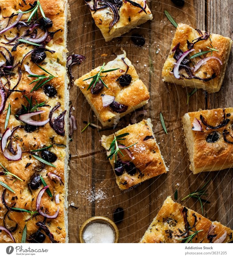 Focaccia with black olives and herbs on wooden table focaccia bread yeast italian bread ingredient handmade onions cooking italian focaccia with herbs