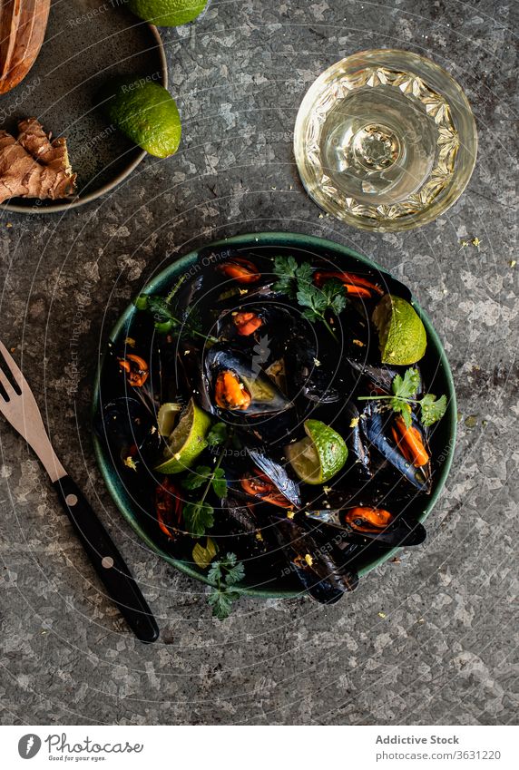 Steamed mussels in bowl on the table top view herbs food photography ginger steam spicy background mollusk menu wine meal steamed eating delicatessen prepared