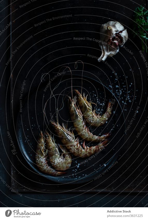 Prawns served in plate on table on dark background dark mood sea food plate seafood raw fish prawns cold culinary marine cooking appetizer delicious top fresh