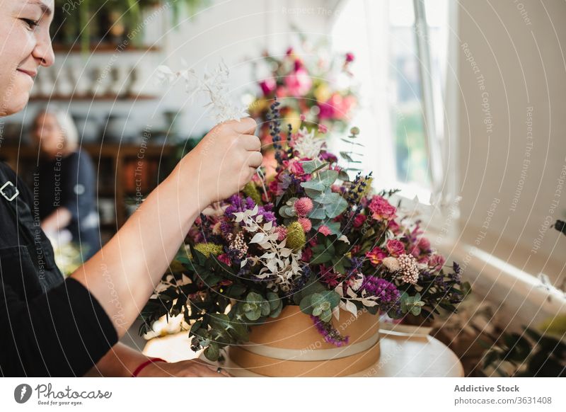 Female designer creating floral bouquets in studio floristry woman arrange create bloom blossom compose decorative female creative work occupation professional