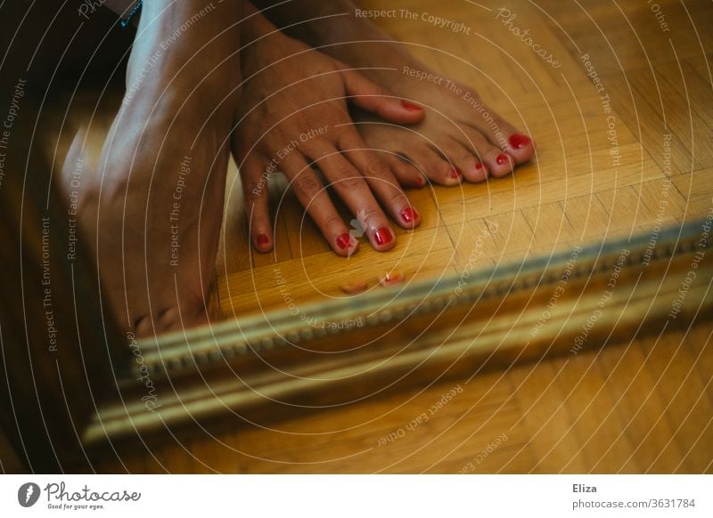 Feet and hand with red painted nails in front of a mirror foot red nails Nail polish Pedicure Varnished toenails Barefoot Red Feminine Legs Skin Ground floor