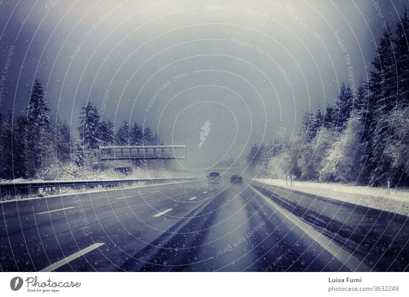 Germany, Bavaria, highway with rare traffic under snowstorm in winter car landscape white road forest wood fir tree vehicle lights season asphalt weather cold