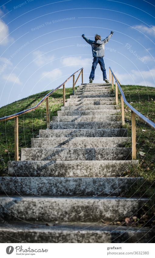 Boy On Top Of Outdoor Stairs On Hill Celebrates Success achieve achievement ambitious business career celebrate celebration challenge champion child climate