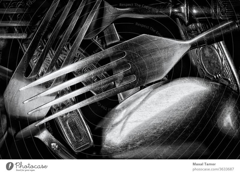Abstract black and white photo of mixed silver forks, spoons and knives abstract closeup cutlery decorated decoration dining dinner effect food inox kitchen