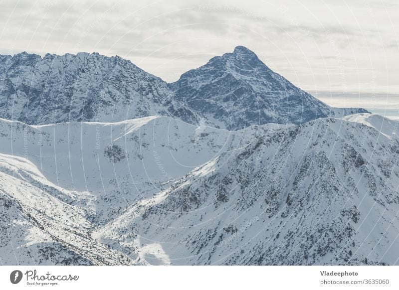 Snowy peak Swinica of the Tatry mountains on the border of Poland and Slovakia. winter swinica landscape snow nature sky cold slovakia rock travel cliff ice