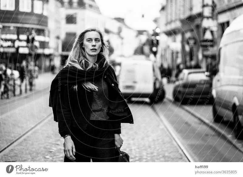 the woman crosses the street and looks sceptically about the coming... Feminine Woman Head Face of a woman Young woman 18 - 30 years Meditative Blonde Adults