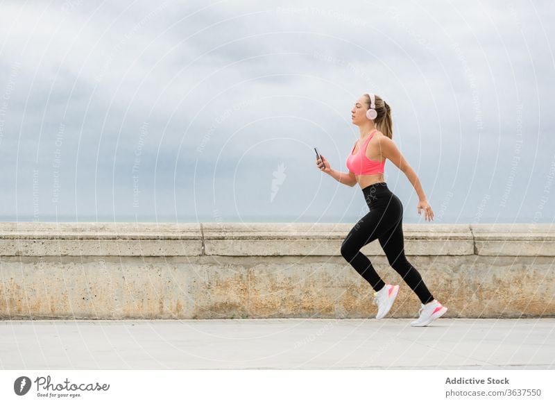 Young woman running in summer park - a Royalty Free Stock Photo from  Photocase