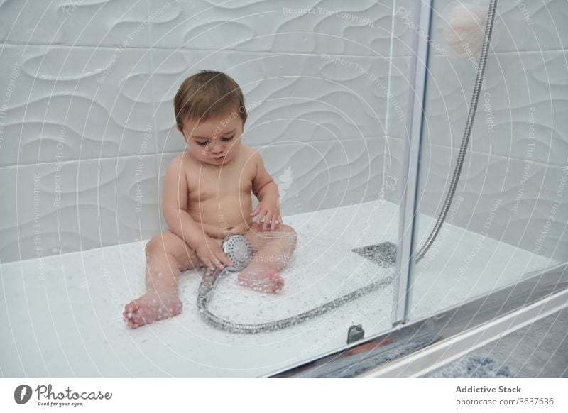 Little baby taking shower water enjoy hygiene bathroom cute toddler little procedure child adorable childhood care smile sit routine wellbeing clear refreshment