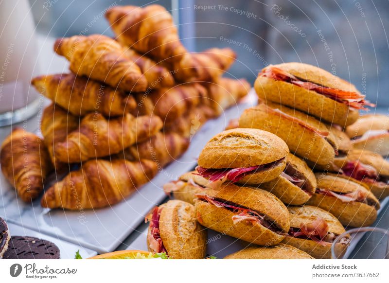 Delicious sandwiches and croissants on table bacon home party delicious food meal plate snack fresh serve sweet tasty pastry gourmet cuisine yummy bread baked