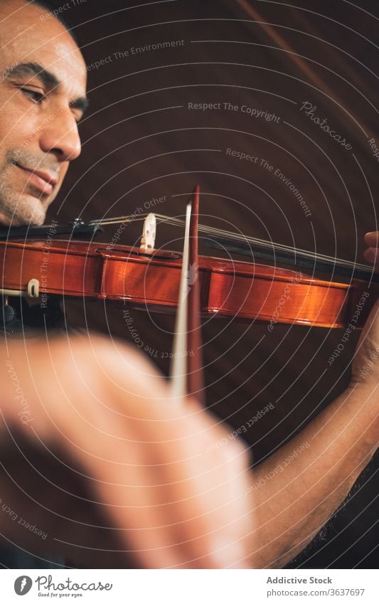 Ethnic male musician playing violin instrument man talent sheet violinist melody ethnic hispanic perform rehearsal sound entertain tune hobby rhythm player