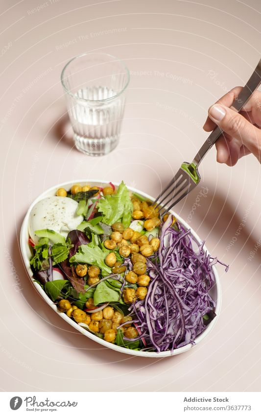 Woman having salad with chickpeas nutrition vegetarian organic food healthy fresh meal vegetable diet cabbage red mix glass water delicious gourmet lunch