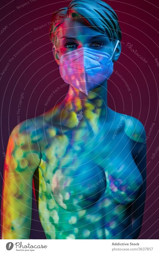 Naked dummy in protective mask in studio mannequin woman coronavirus concept naked medical female plastic illuminate light colorful vivid vibrant multicolored