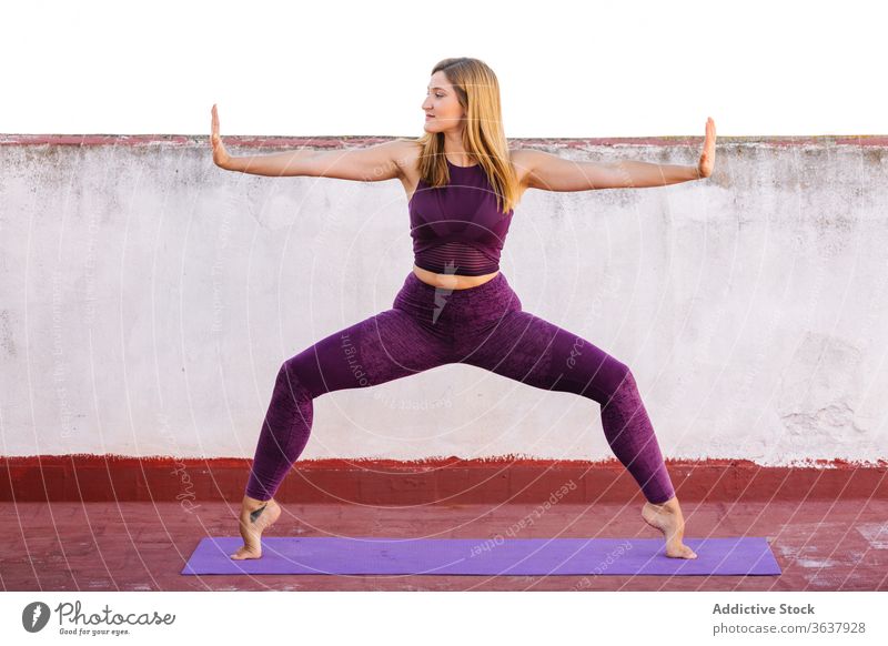 Pregnant woman doing exercises with dumbbells at home - a Royalty