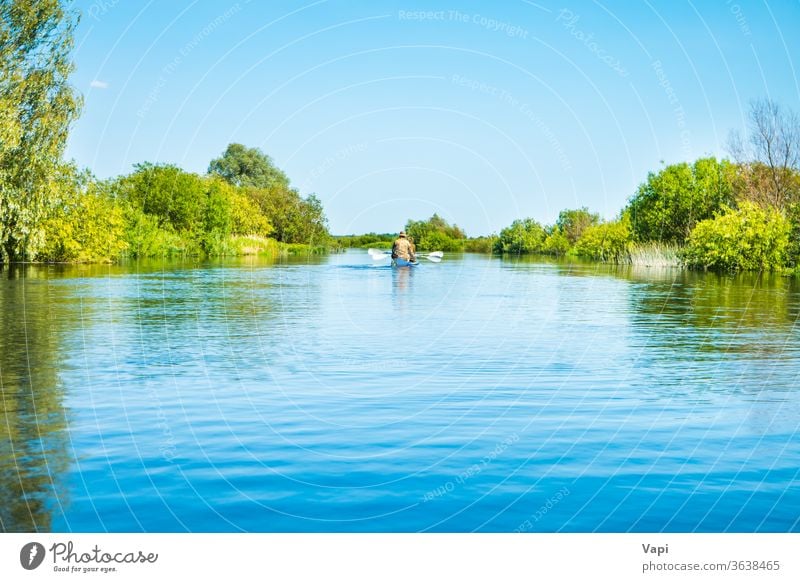 Couple at kayak trip on blue river landscape - a Royalty Free