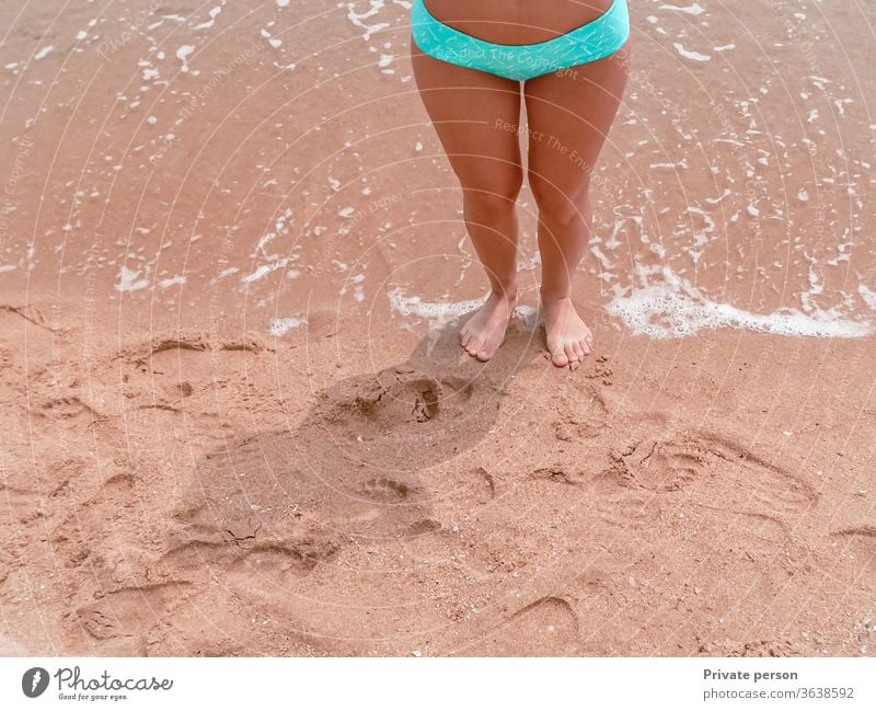 Legs of a woman walking barefoot on the sand of a beach beautiful blue body female girl health holiday leg legs lifestyle natural nature ocean people relax