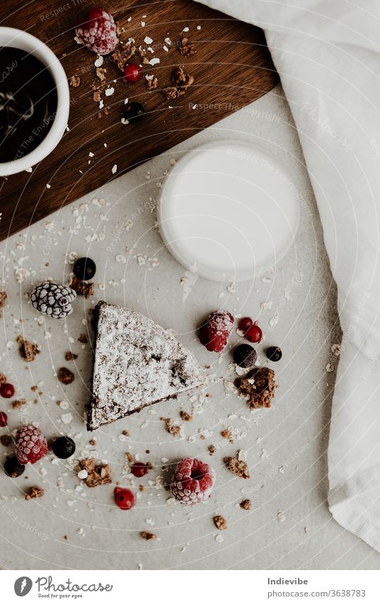 Healthy vegan cake slice with chocolate sauce, milk and berries healthy berry breakfast almond milk blackberry brown background chopping board closeup coconut