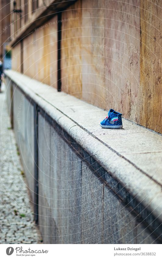 Little children's shoe on the wall Shoe Small Footwear Childrens shoe Shoe sole Colour photo Clothing Sneakers alone child shoes kids shoe Exterior shot Day