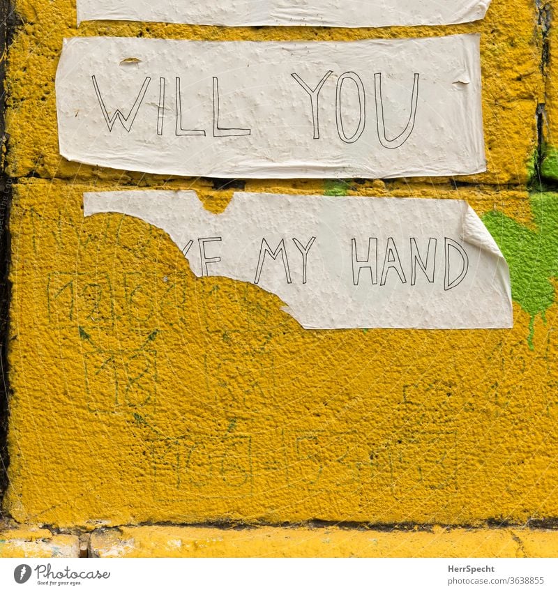 Will you take my hand? Graffiti adhesive tape hold hands by hand Ask torn down pasted embassy Wall (building) Wall (barrier) Characters Yellow incomplete