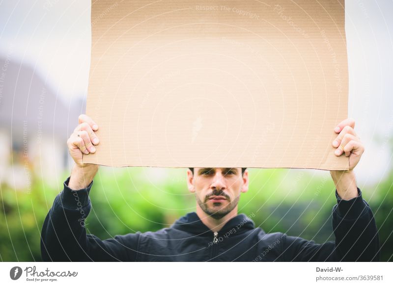 Cardboard box - Man holding a cardboard sign in his hand in the air paperboard cardboard box Clue indicative point esteem Opinion Man Held Copy Space