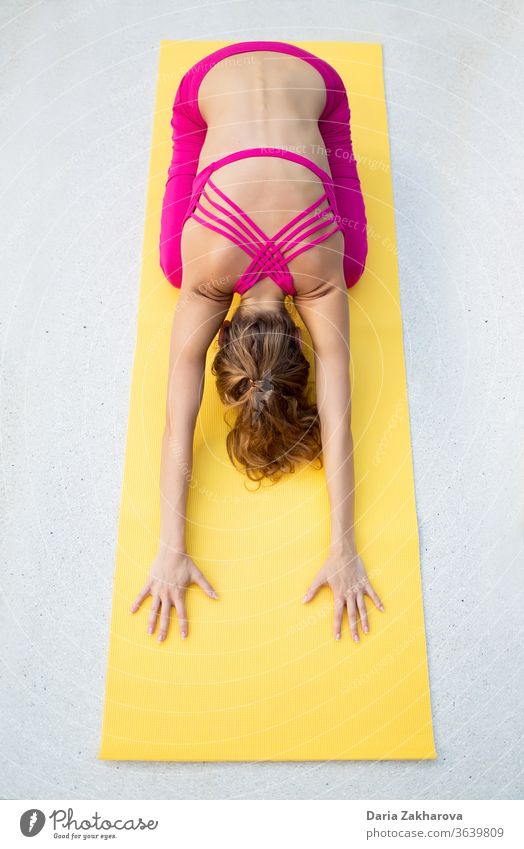 stretching back.photo of the girl doing yoga by the gym mat woman young pose lifestyle fitness concentration female health exercise workout training people