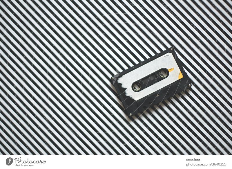 old cassette on striped background then Cassette tape recorder Compact cassette audio cassette Sound storage medium electromagnetically Analog recording Music