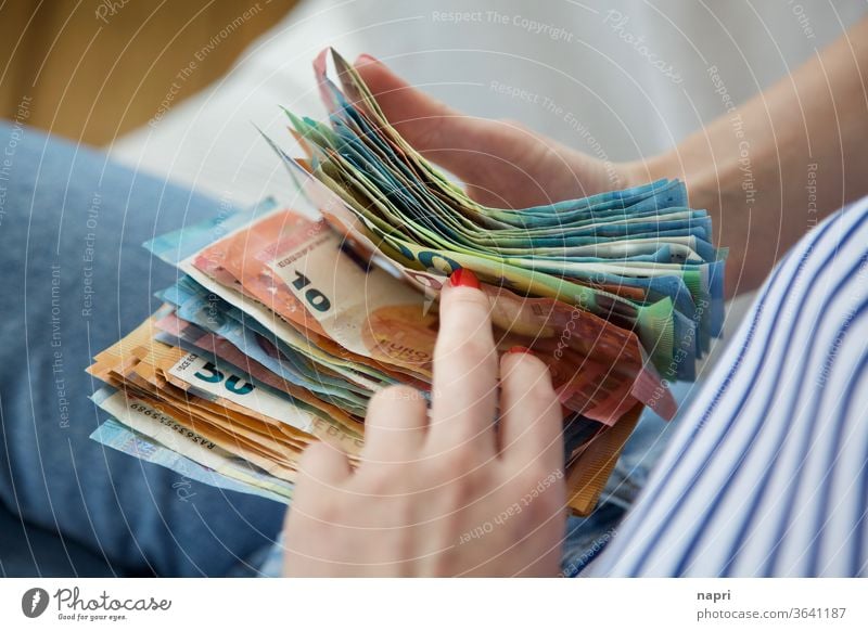 Traveller's cash box | Young woman holds a stack of banknotes in her hands and counts through. Money Bank note Euro Loose change figures Save Income Luxury
